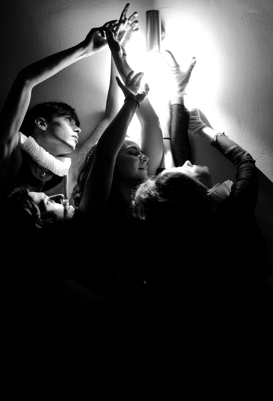 VYR collective — hands reaching toward light